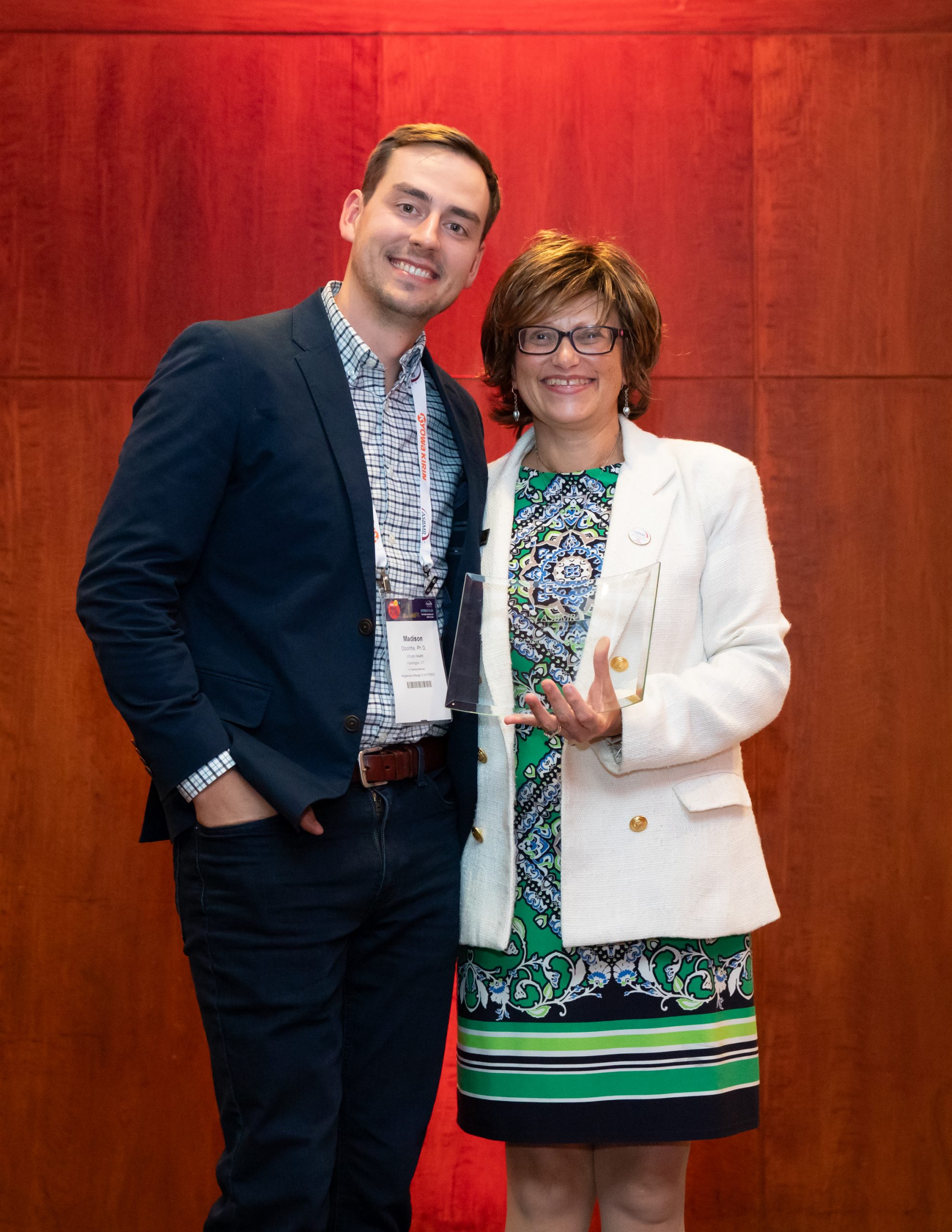 Woman handing man award